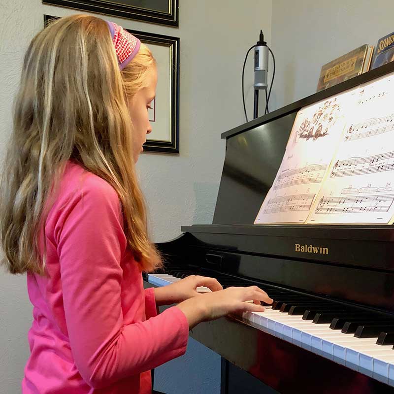 Student practicing on a Baldwin piano